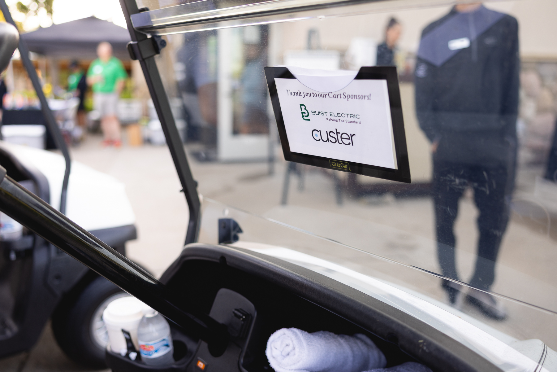 A golf cart at the Mary Free Bed Open carrying a card that thanks the cart sponsors