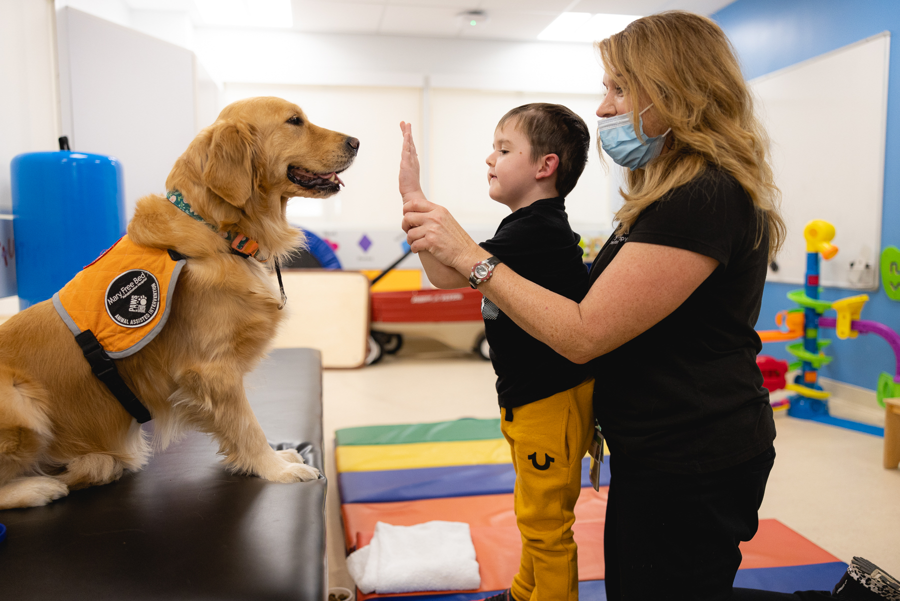 A Mary Free Bed team member talking with a patient and their family