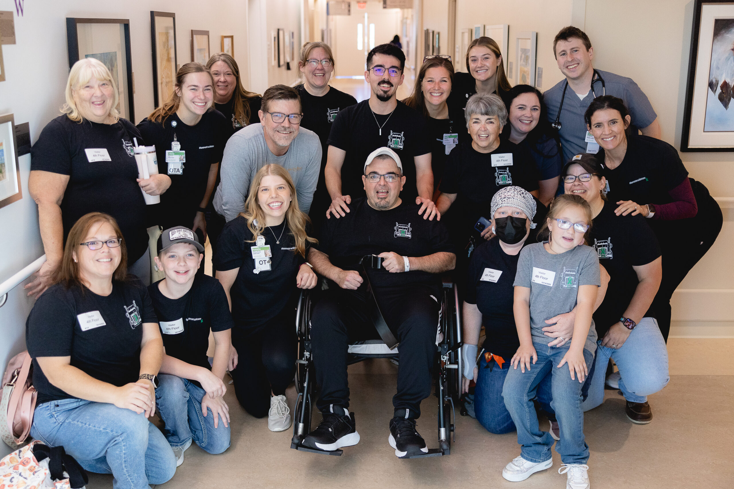 Tony in his wheelchair surrounded by his Mary Free Bed care team