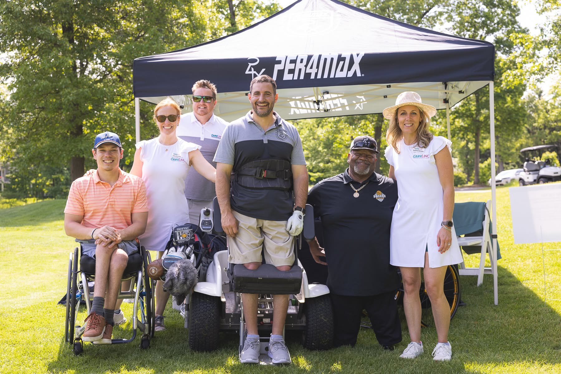 Sponsors and adaptive athletes under a tent at the Mary Free Bed Open golf outing