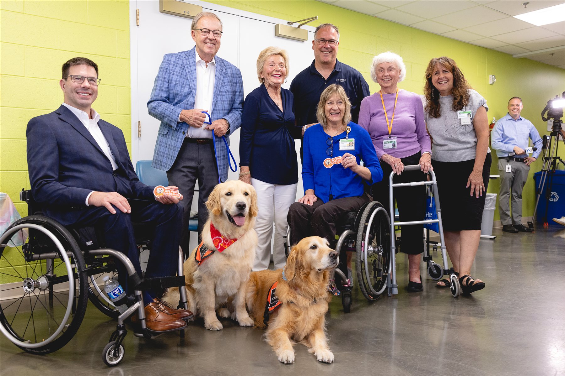Community partners, patients and Mary Free Bed team members gathered with two golden retriever therapy dogs at a welcome event