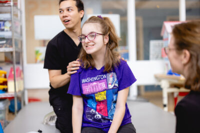 cerebral palsy patient shown smiling with Mary Free Bed therapist