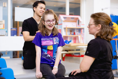 cerebral palsy patient shown smiling with Mary Free Bed therapist