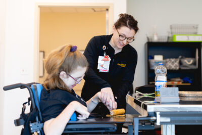 cerebral palsy patient doing therapy exercises with Mary free bed therapist