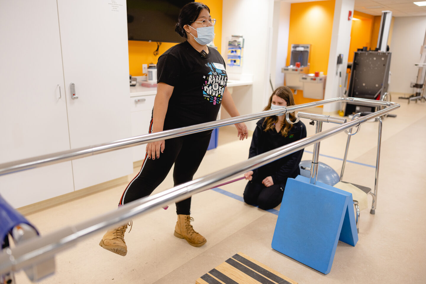 Young patient doing exercises for chronic pain with a specialist.