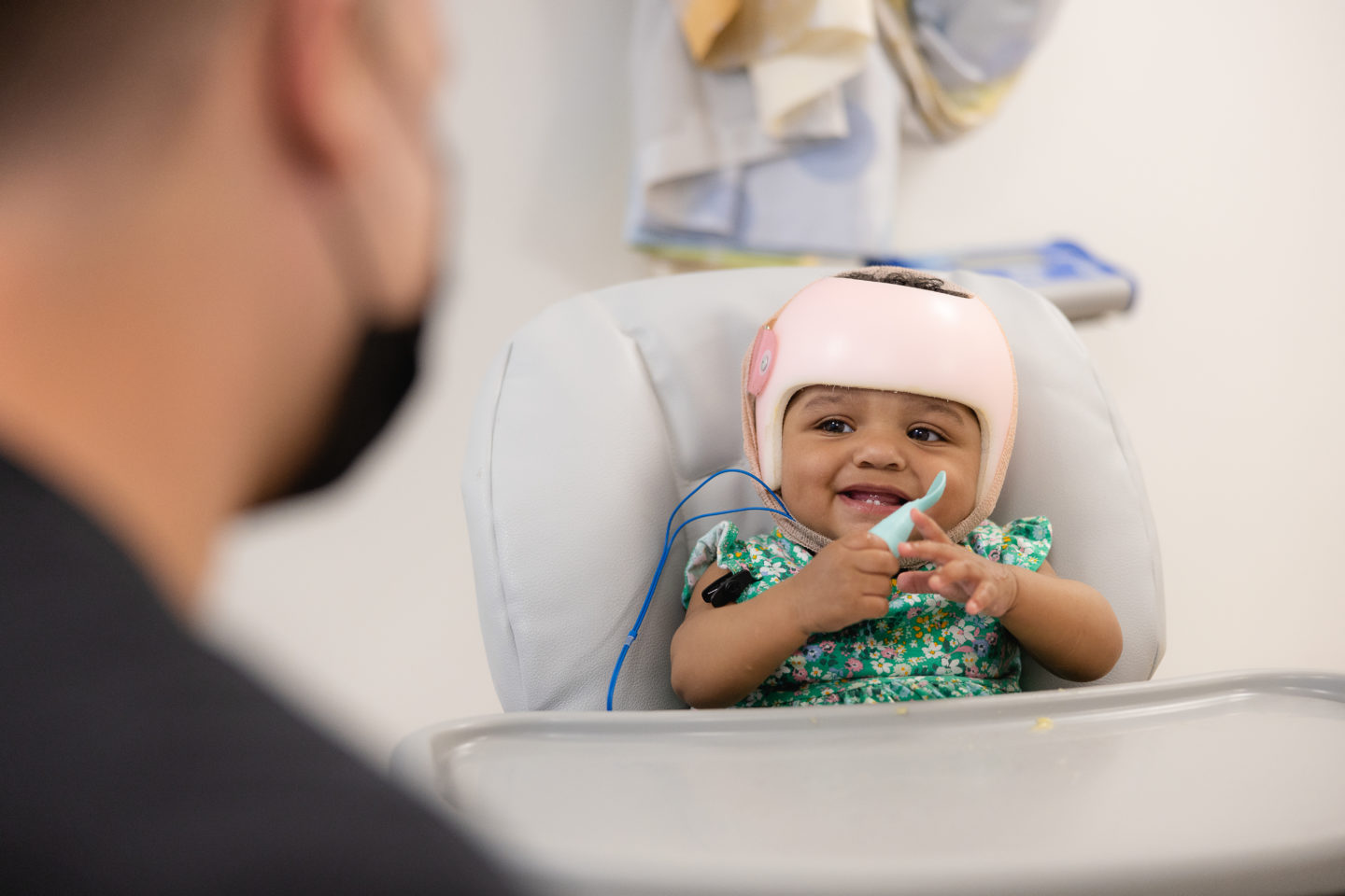 Zailee Johns eating in a high chair.