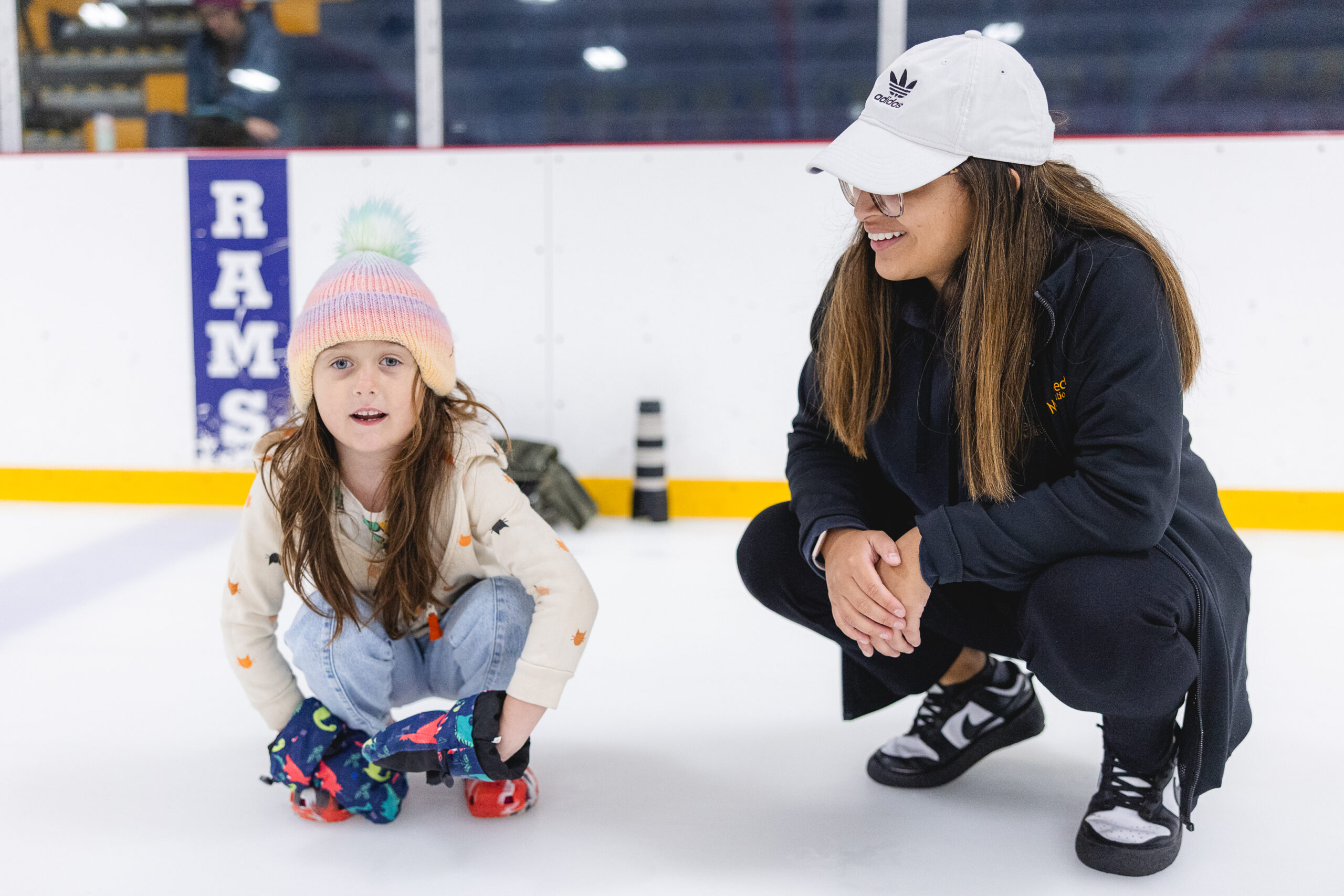 Mary Free Bed staff with child patient at adaptive curling clinic