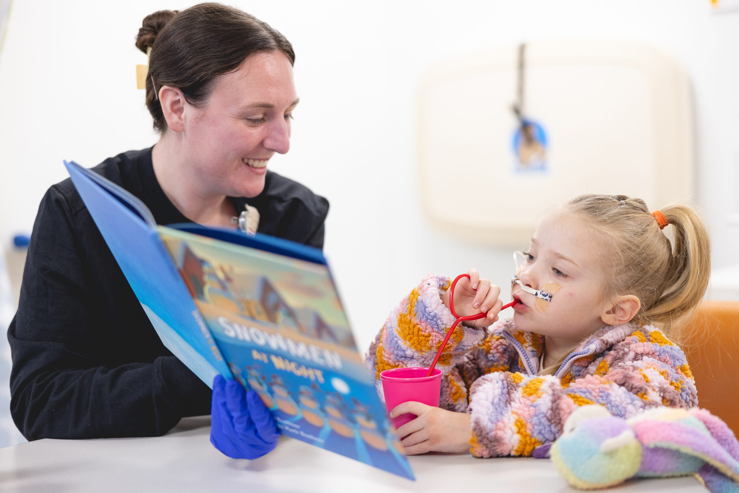 A therapist supporting a patient through a feeding program therapy session