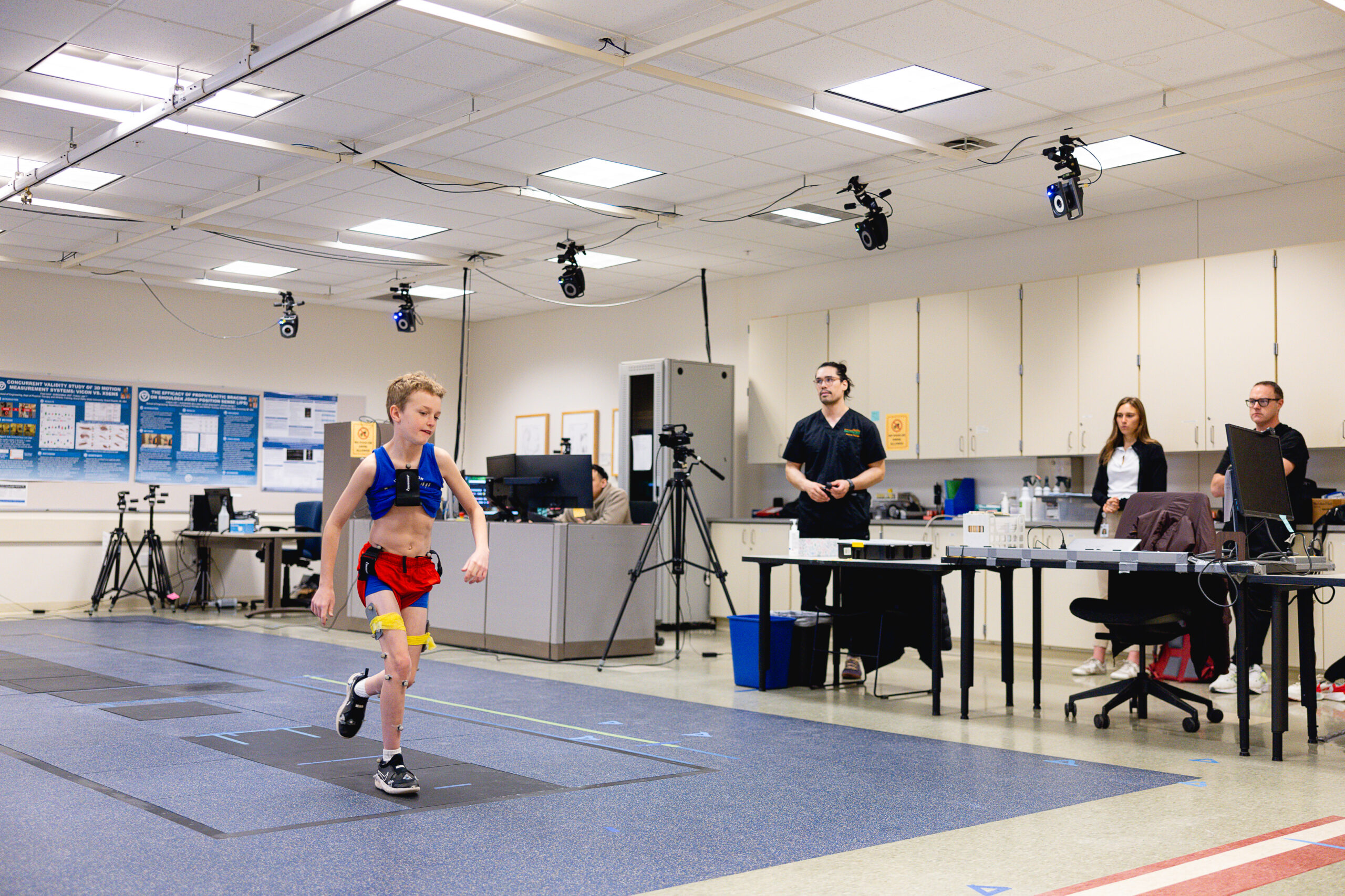 a child walking across a specialized platform as part of a motion analysis
