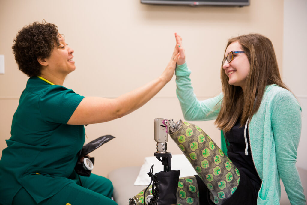 a pediatric patient giving a clinician a high-five