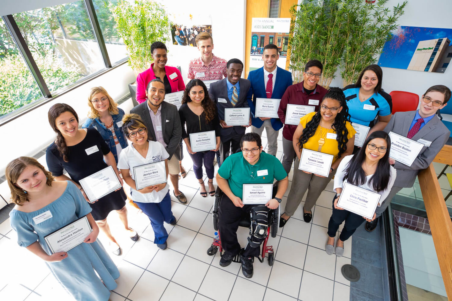 2019 Disability and Minority Scholarship Recipients Group holding their certificates, posing in a bright indoor setting.