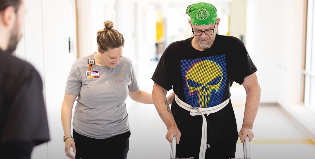 Amputation patient walking with a specialist at Mary Free Bed.