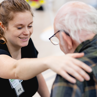 Brain Injury 46 physical therapist assisting patient