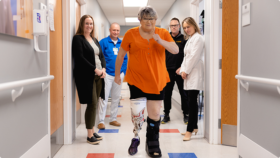 Amputation specialists watching a patient walk.