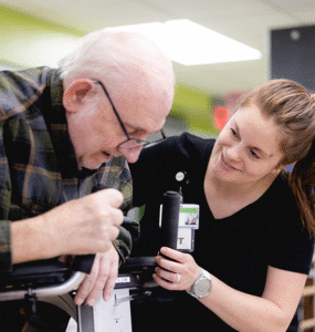 Specialist helps patient in day rehab.