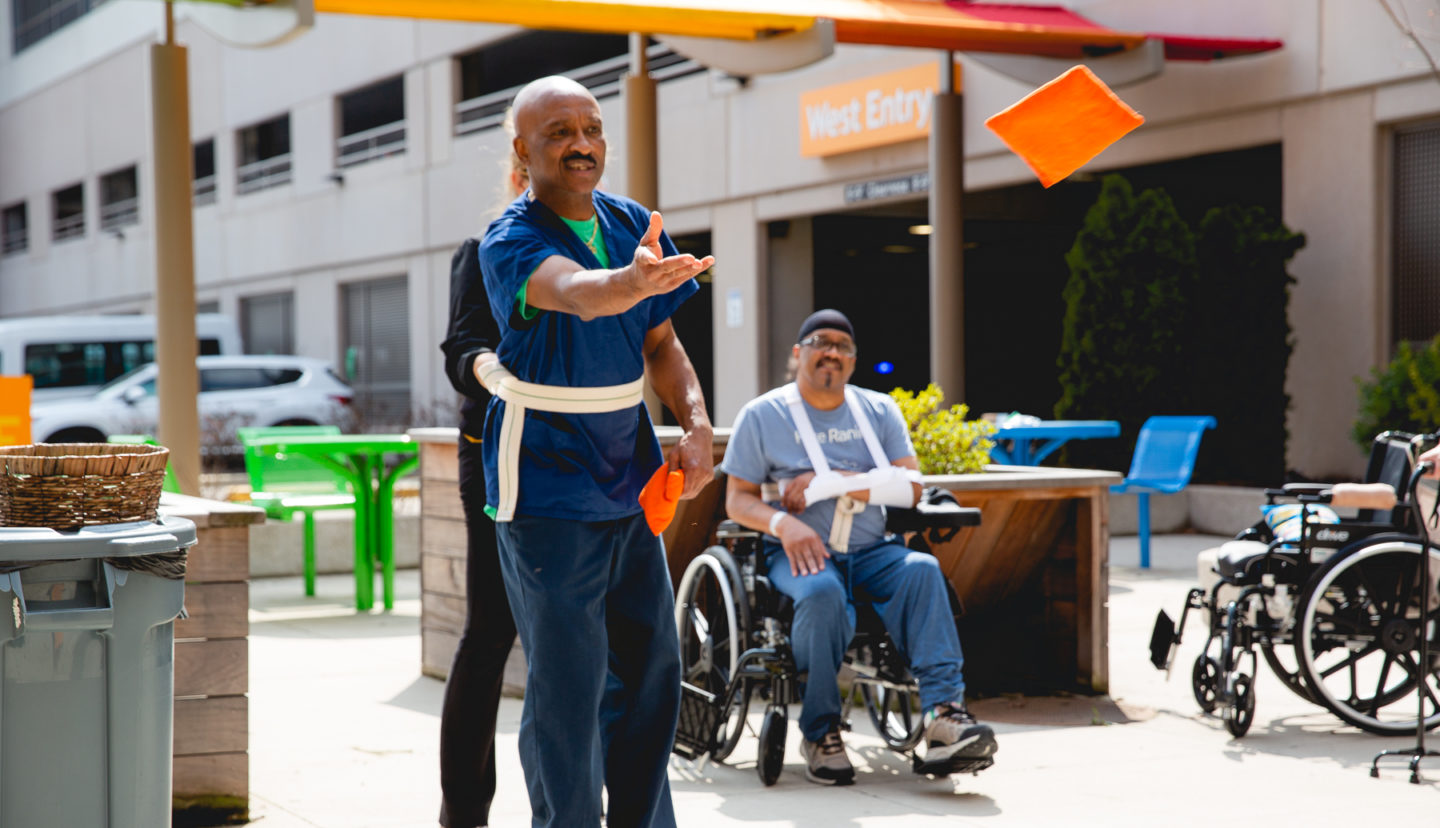 Ricky and Corbie tossing bags during therapy