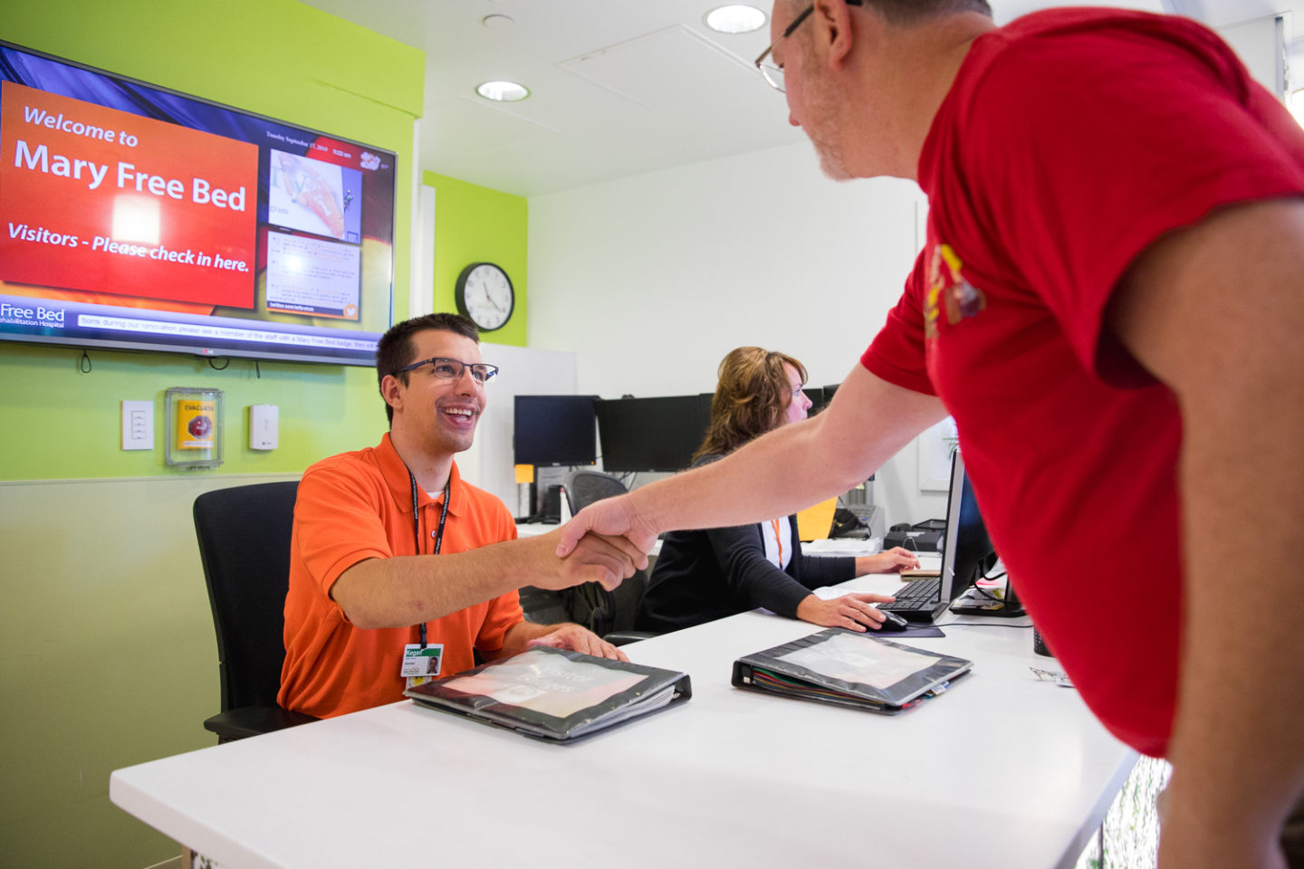 Volunteer Keegan greeting visitors