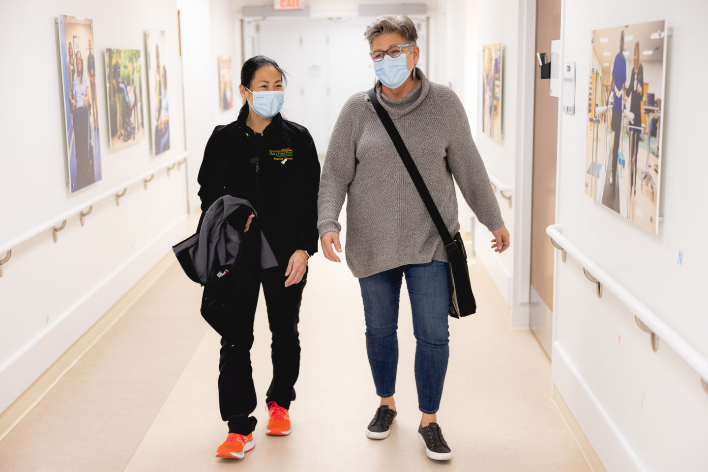 Cancer rehabilitation patient walking with physical therapist at Mary Free Bed