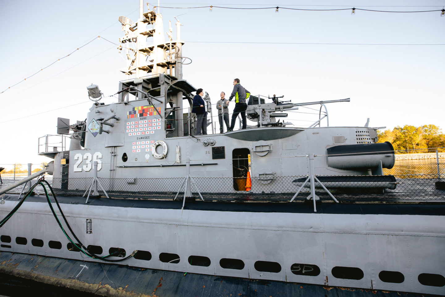 Peggy standing on World War II submarine with her physical therapist