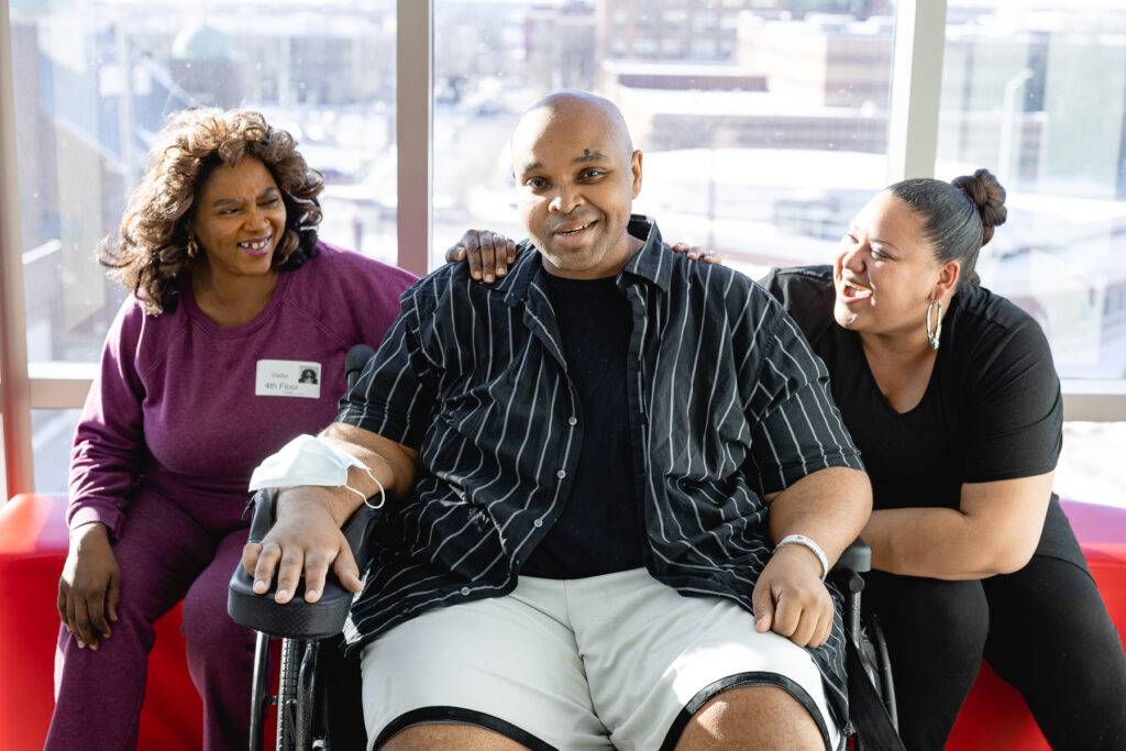 Lavell and his family members smiling during his inpatient recovery.