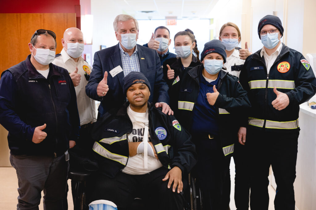 Lavell and his colleagues smile for the camera on Lavell's graduation day.