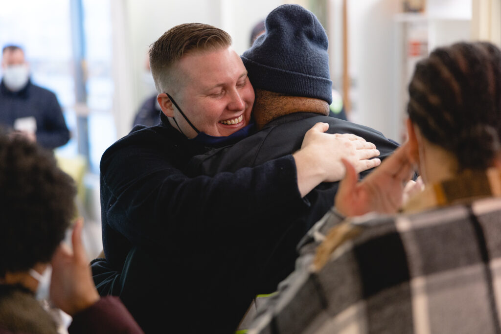 Lavell and his colleague embrace each other on his graduation day.