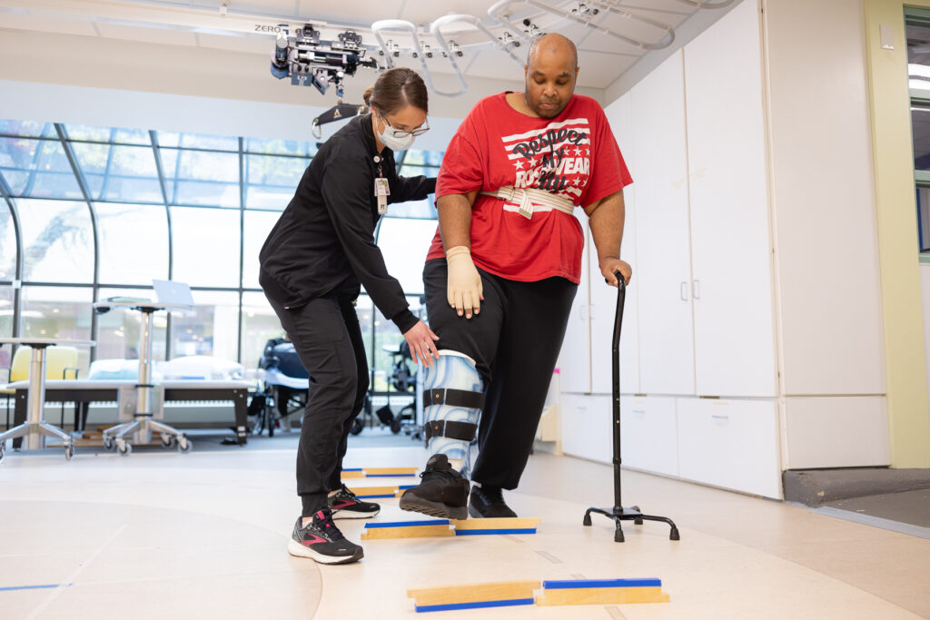 Lavell and his physical therapist practice walking in outpatient therapy.