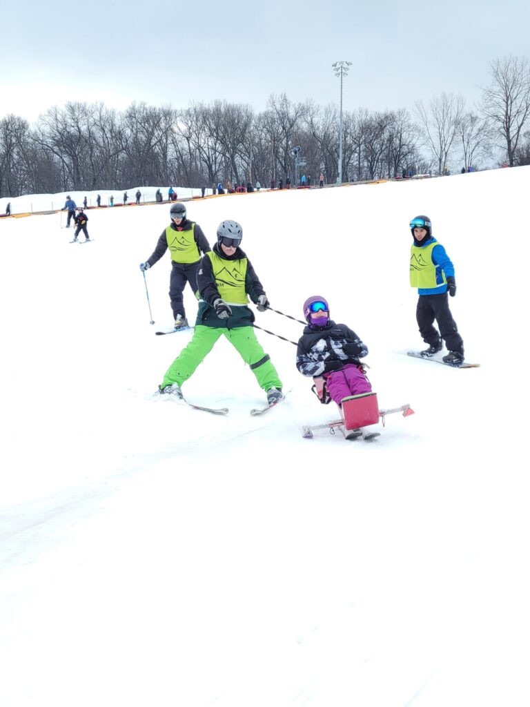 Loralei skis down a snowy hill in the winter