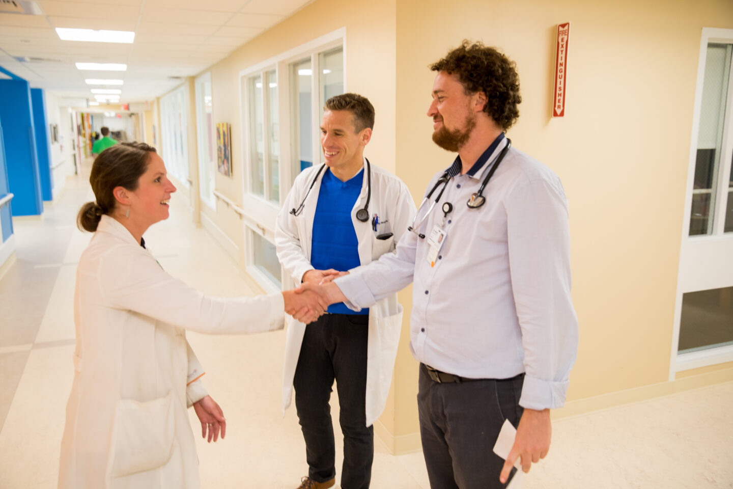 Mary Free Bed resident shakes hands with residency leadership