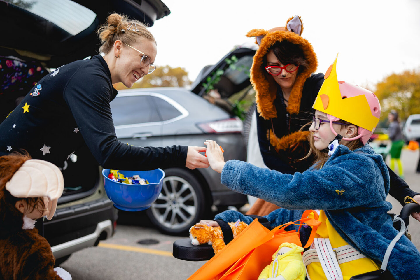 Hospital Staff Giving Treats to Patients at Trunk-O-Treat event