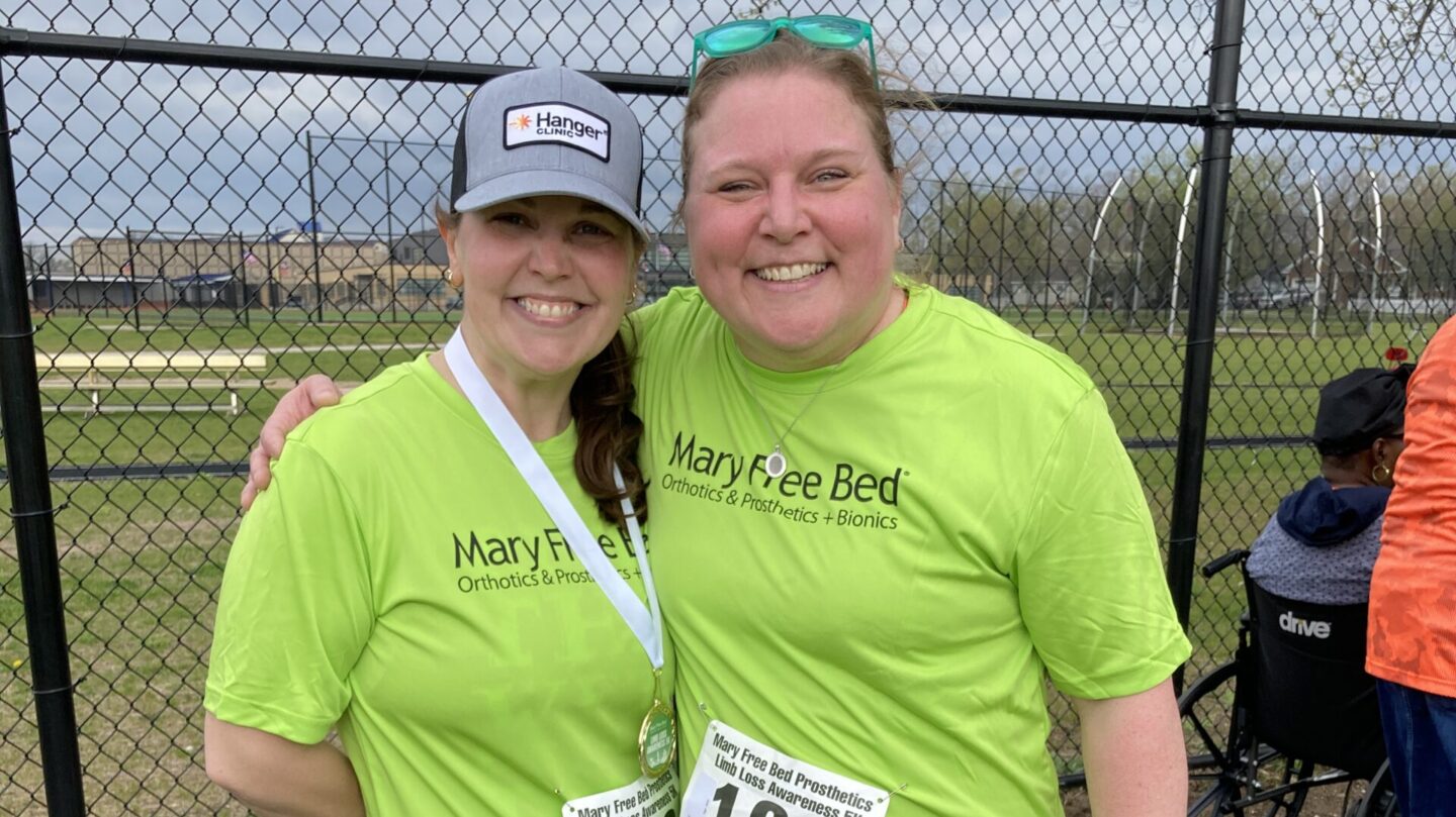 two runners after a 5k wearing green mary free bed shirts