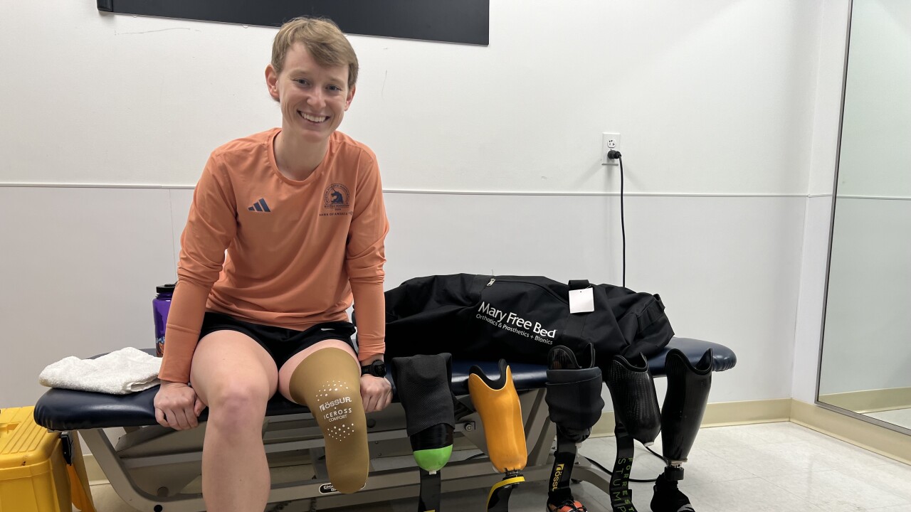 Nicole Ver Kuilen Siting in treatment room with her prosthetic legs