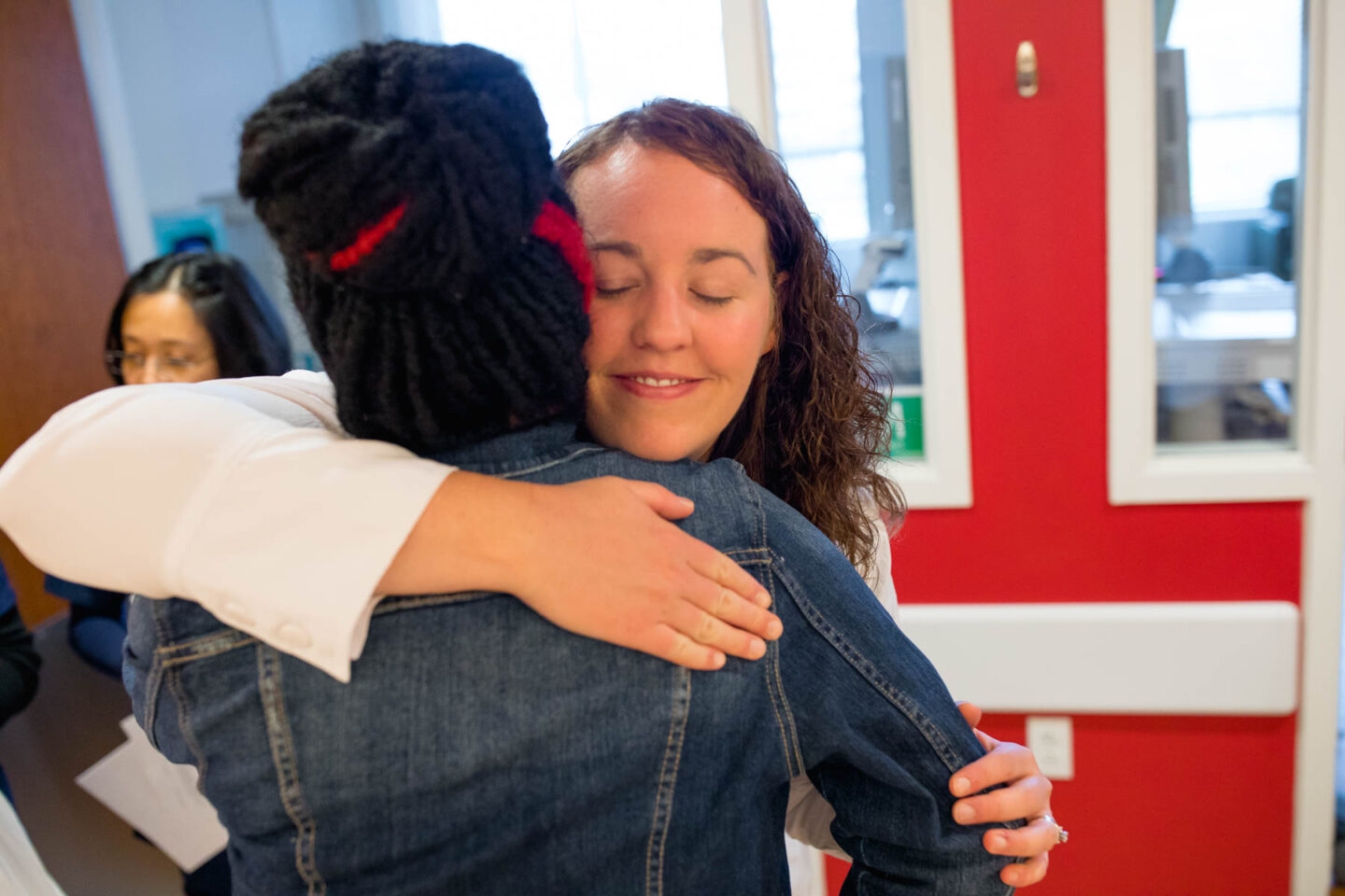 A patient hugs Stephanie Rose, Mary Free Bed Amputee Liaison, in the orthotics and prosthetics clinic.