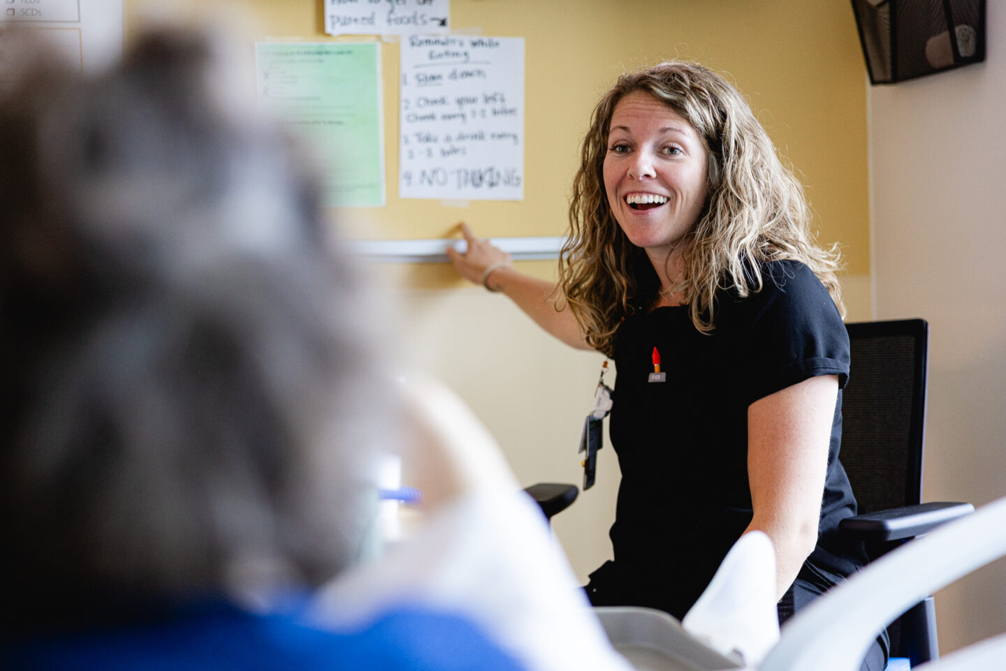Therapist engaging with a senior stroke patient with interactive and effective speech rehabilitation techniques.