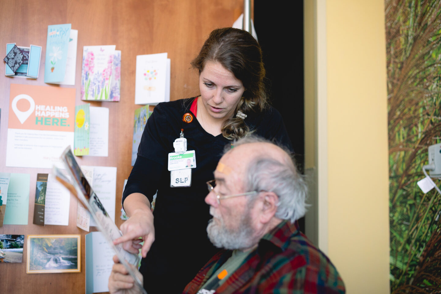 Speech-language pathologist working with a patient on speech therapy tasks.
