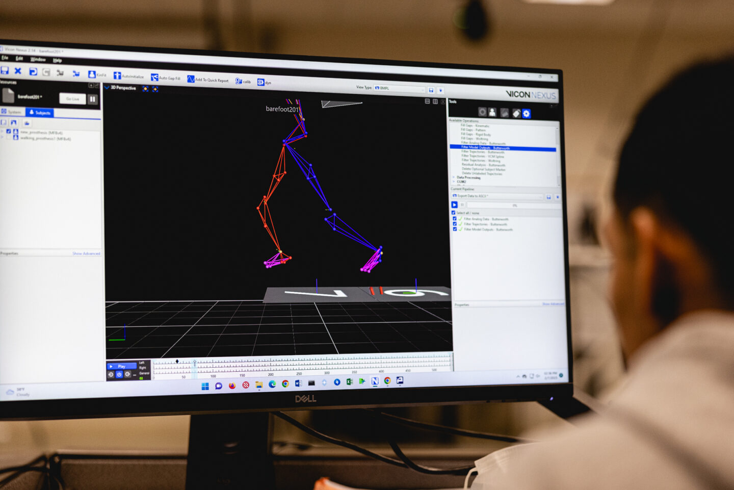 Computer screen displaying motion capture data of runner's gait analysis.