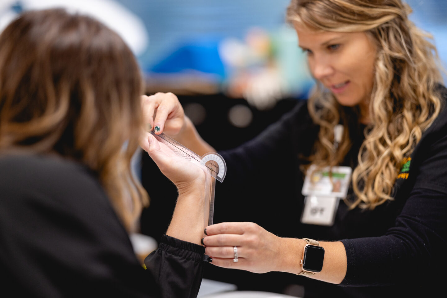 Occupational therapist assessing hand mobility in a hand therapy session