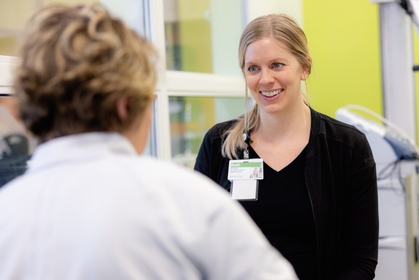 A driver rehabilitation specialist consults with a patient.
