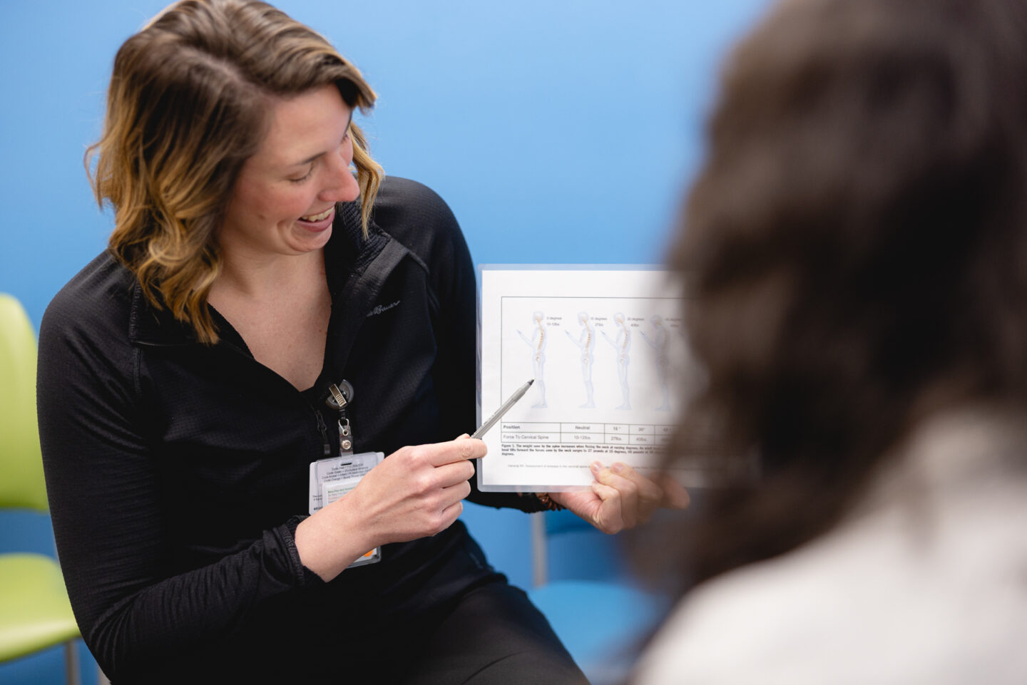 Mary Free Bed clinician discussing holistic back pain treatment options with patient.