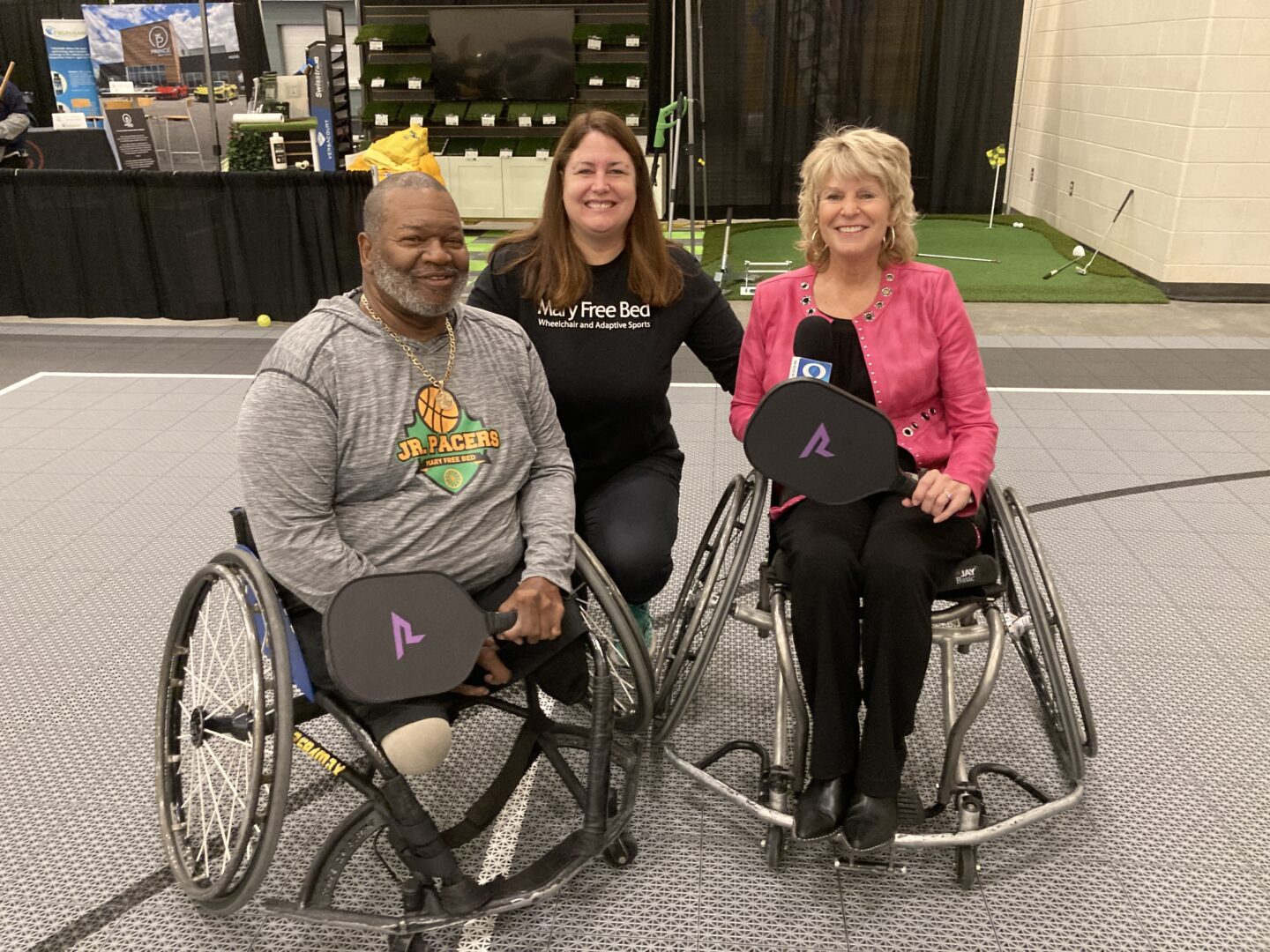 three people smiling at the camera after playing wheelchair pickleball
