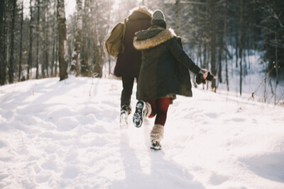 Manage holiday stress with these simple tips 26 stress relief for the holidays couple running in the woods on snow