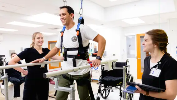 A stroke patient using a gravity-assisted treadmill as part of a therapy session.