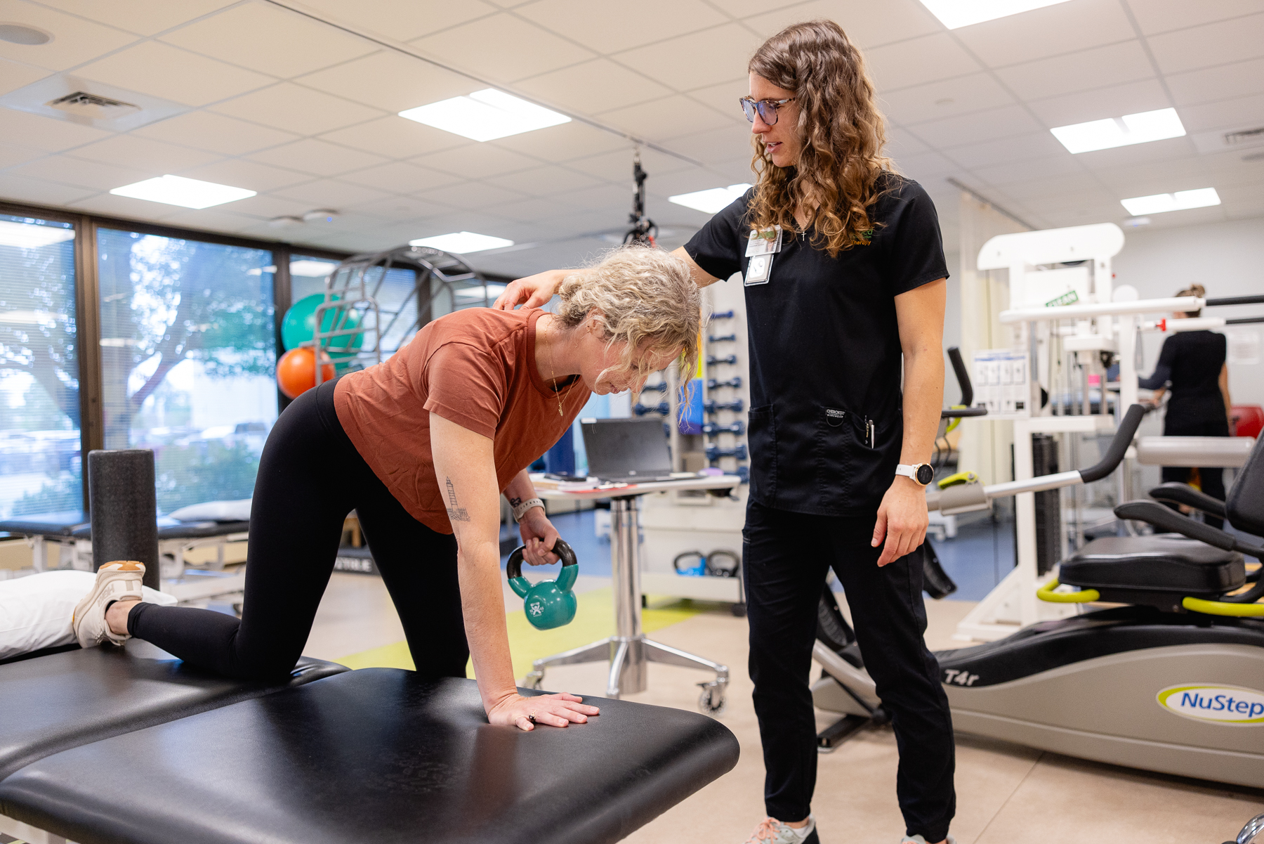 Patient in sports rehabilitation being helped by a Mary Free Bed professional.
