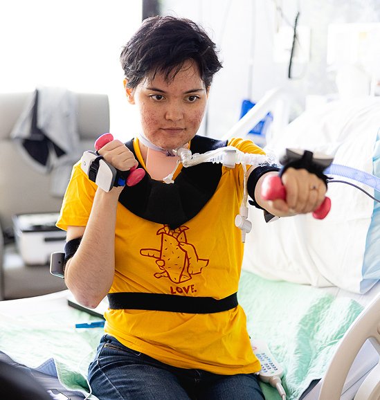 patient doing rehab exercise with hand weights