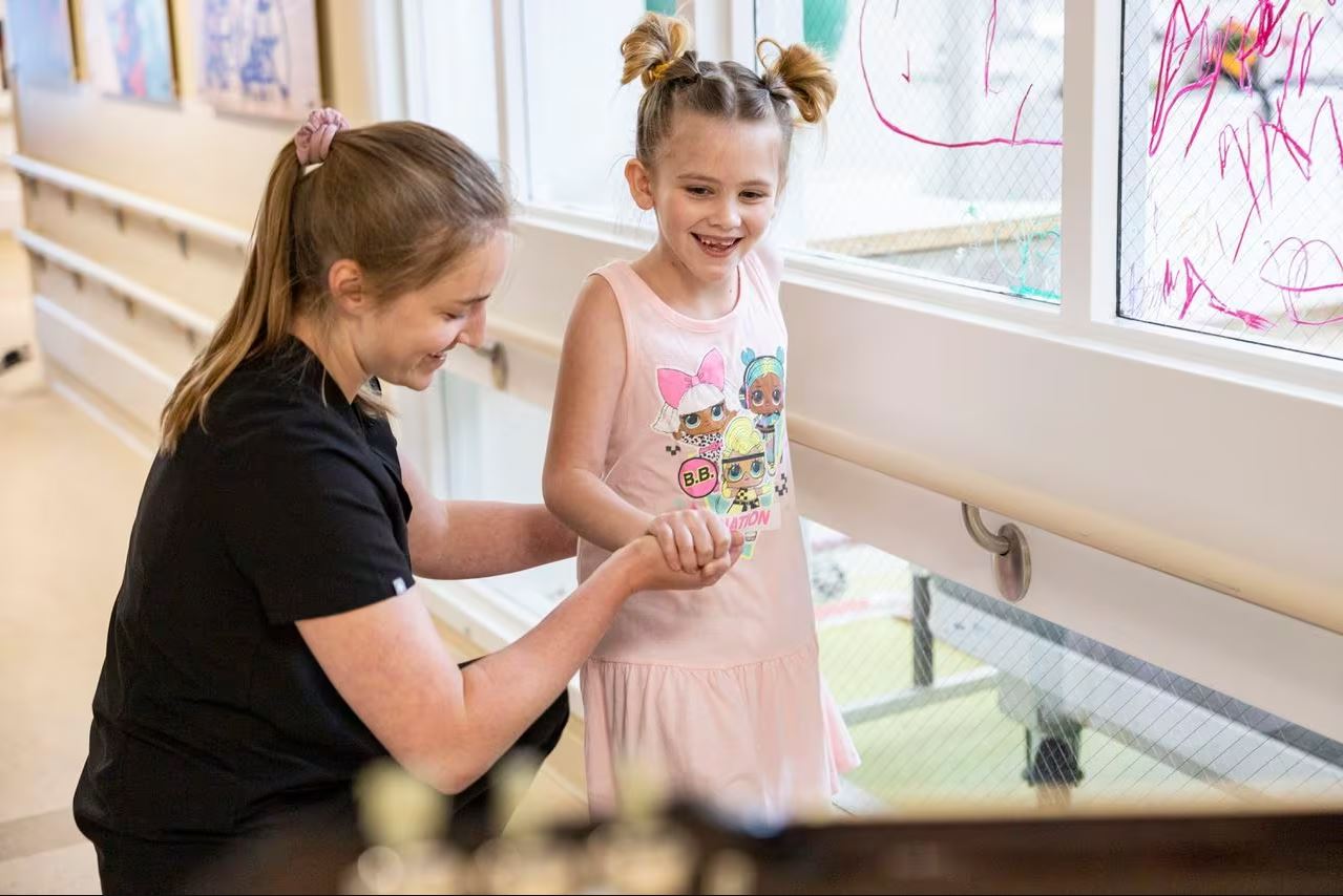 In The Media 51 Young patient, Bella, being helped by specialist at Mary Free Bed.