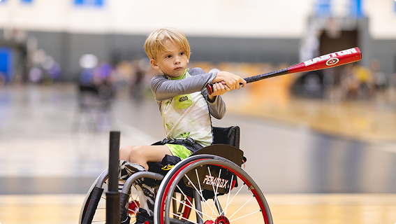 A World-Class PM&R Residency Program 7 Young patient in a wheelchair playing tee ball.