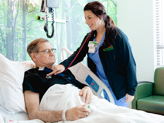 Patient receiving respiratory therapy in a treatment room.