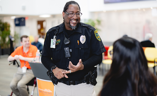 security guard talking to patient in lobby of Grand Rapids Hospital