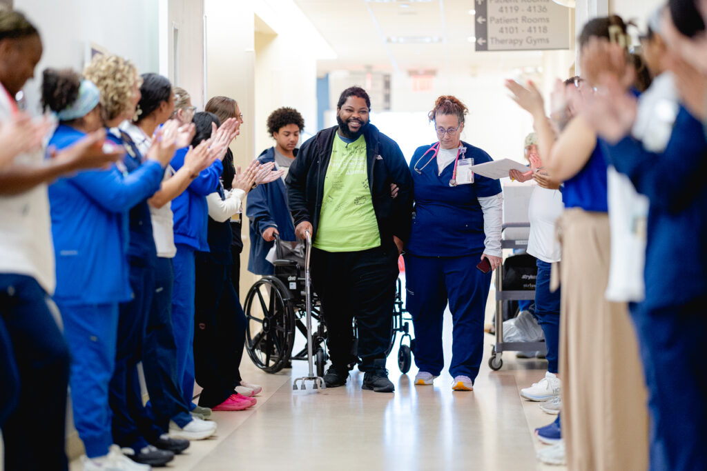 Mary Free Bed Multiple Trauma Patient at graduation with therapy team