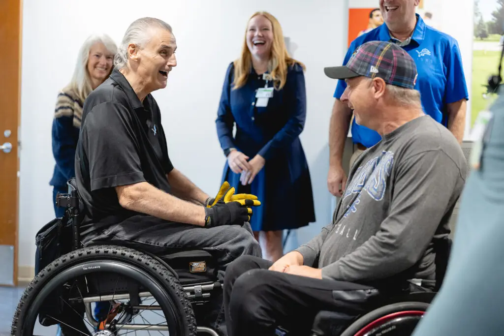 Mike Utley speaking with another wheelchair and adaptive sports athlete